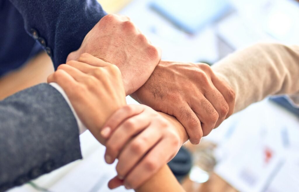person in black long sleeve shirt holding persons hand